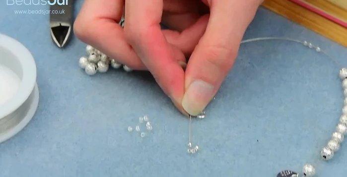 Tuck the excess wire into the beads.