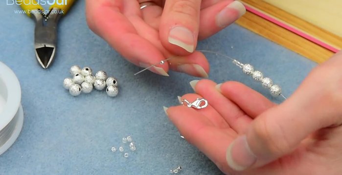 Tuck the excess wire into the beads.