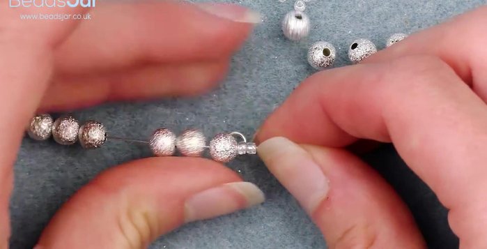 Tuck the excess wire into the beads.