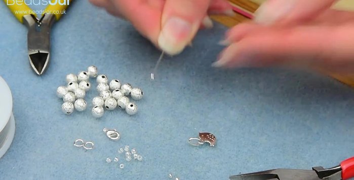 Attach a crimp bead to the wire using flat nose pliers.
