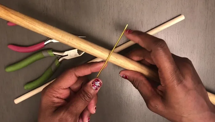 Bring the wire down and wrap it around the base of the already created structure.