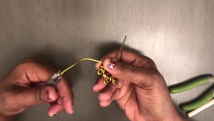 Use a dowel to form a loop at the top of the earring, then cut off the excess wire.