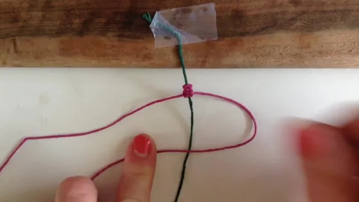 Alternate sides for the next knot: this time, take the other side over the center, then the other side under, and back over through the loop.