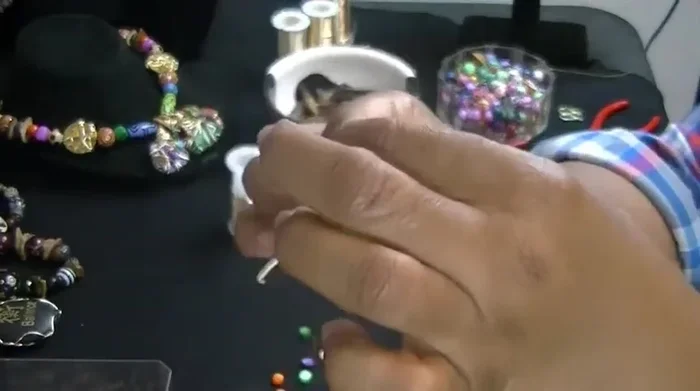 Pinch the wire again and twist it to secure the loop.