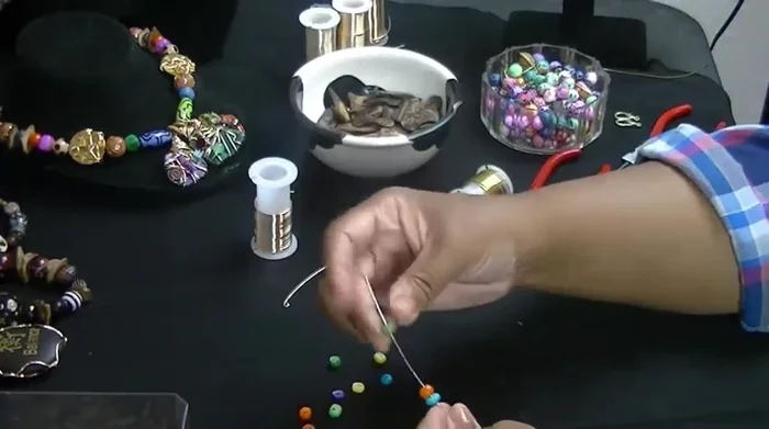 Pinch the wire again and twist it to secure the loop.