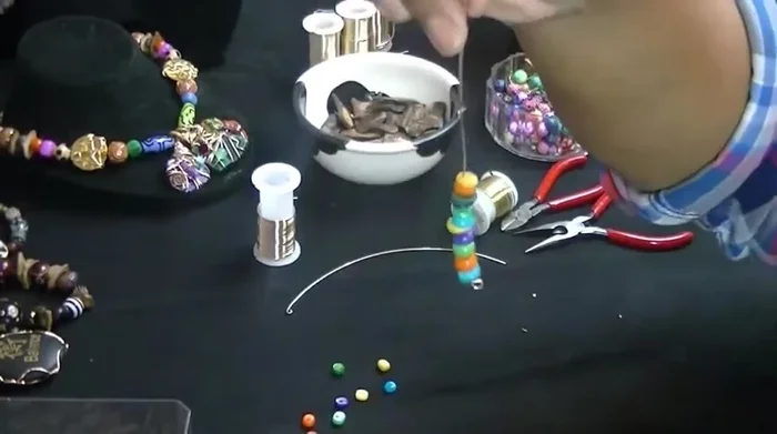 Pinch the wire again and twist it to secure the loop.