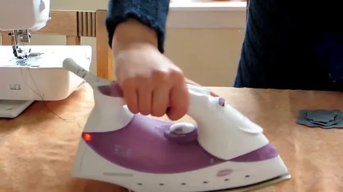 Sew a star shape through all the layers to secure them together. This helps give the brooch body and shape.