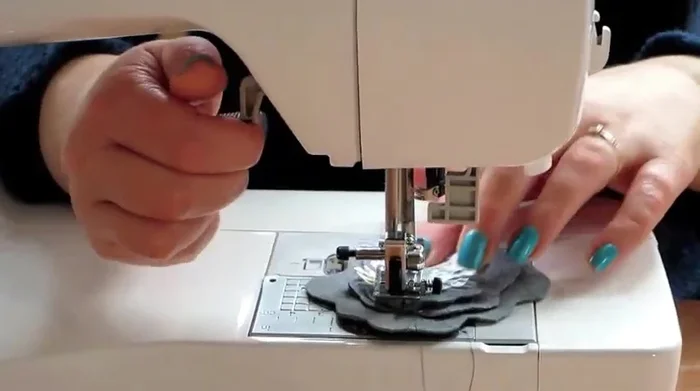 Sew a star shape through all the layers to secure them together. This helps give the brooch body and shape.