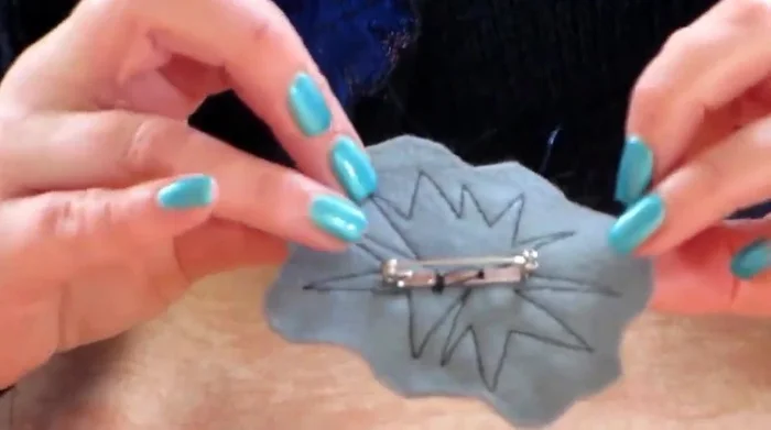 Attach the brooch pin to the back.