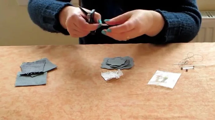 Place the heat-resistant paper on top of the smallest felt piece, cover with greaseproof paper, and iron to bond the layers. Repeat for the other flower pieces.