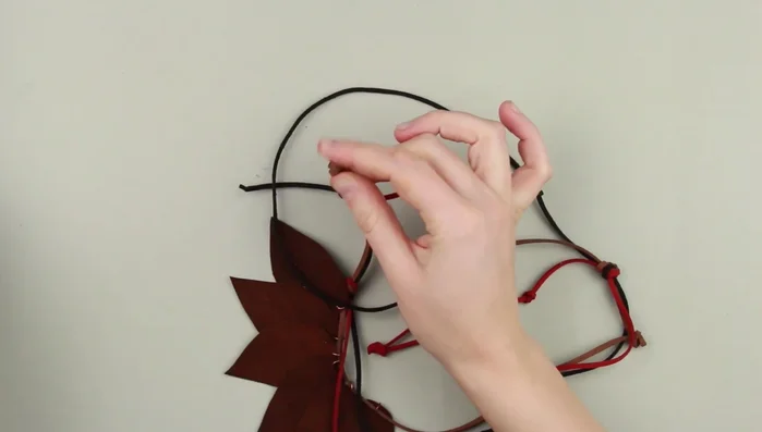 Tie decorative knots at the ends of each cord.