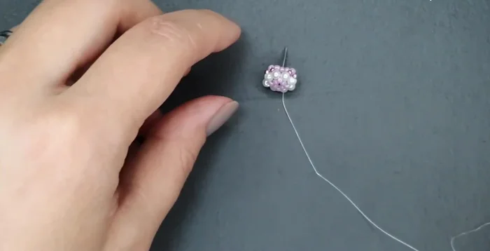 Add the 4mm pearls: Add rows of 4mm pearls using 2 size 15 beads before and after each pearl.