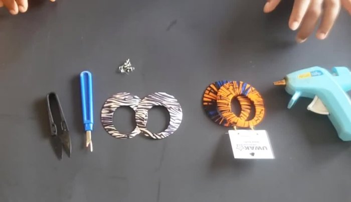 Prepare your materials: scissors, seam ripper, hot glue gun, earring template, earring hooks, and fabric strips (slightly larger than 1/2 inch wide and about 30 inches long).