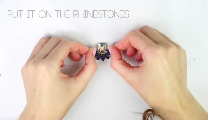 Secure the rhinestones with scotch tape, maintaining their shape.