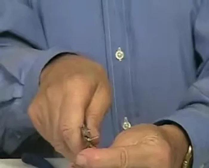 Close the loop by bending the top with your pliers, holding it tight while transferring it to another hand. Use your active hand to bend the wire, making two or three loops.