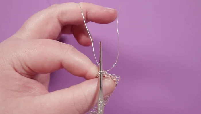 Cut off excess wire; secure the end by wrapping it around existing wires a few times and tucking it in using pliers.