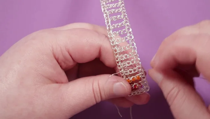 Attach ribbon ends to both ends of the bracelet using glue for extra durability; clamp down with pliers.