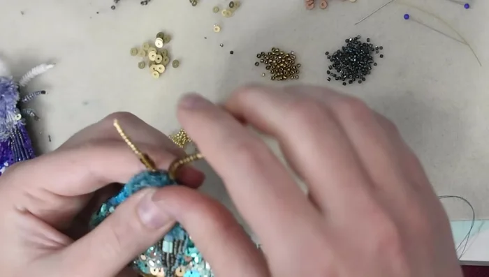 Arrange the moth's features and secure with stitches.