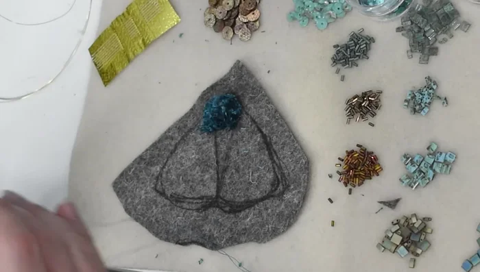 Outline the beaded body section with French knots.