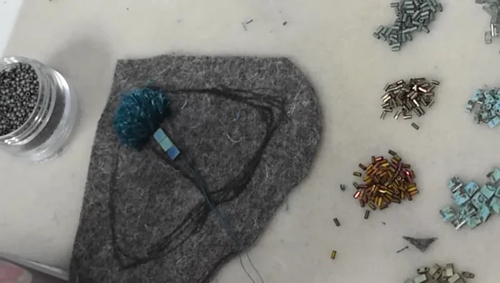 Outline the beaded body section with French knots.