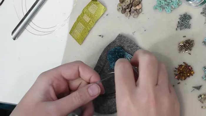 Outline the beaded body section with French knots.