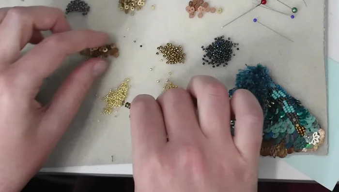 Arrange the moth's features and secure with stitches.