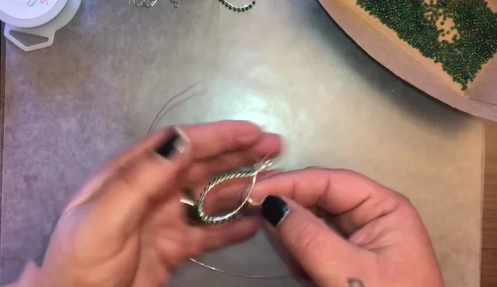 Continue adding beads and wrapping the wire until you reach the desired length. Cut off excess wire, leaving a small tail.