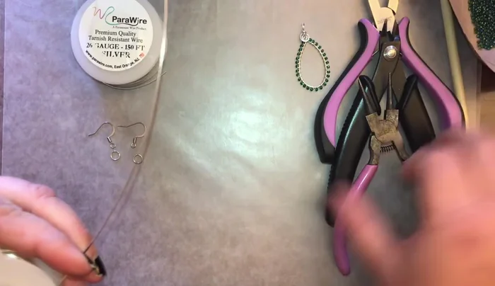 Cut approximately six inches of 20 gauge wire for the earring (or pendant). Bend one side over the other to form a teardrop shape. Twist the wire twice where the two sides meet.