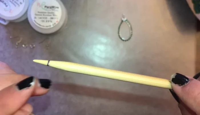 Use a knitting needle to create a loop at the top of the teardrop. Straighten the wire if needed.