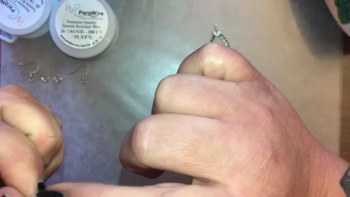 Wrap the wire from the loop around the base of the loop to secure it. Use pliers to help with wrapping if desired.