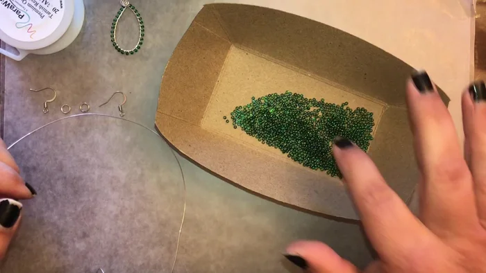 Start adding beads one at a time to the 26 gauge wire. Push each bead close to the teardrop. Wrap the wire around the teardrop twice after each bead.