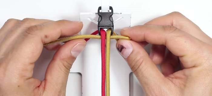 Secure the red cord: Pass the red cord from the top through the middle and through the loop on the left side.