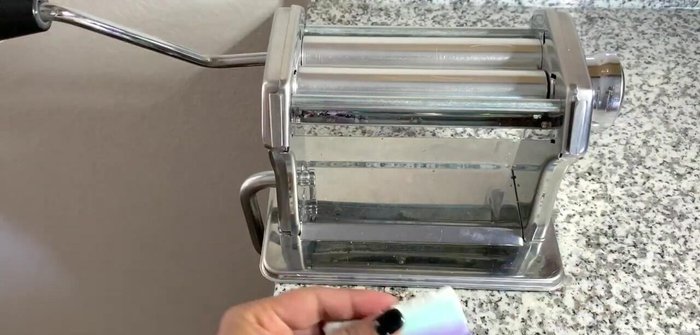 Fold the clay in half, push the sides in, and repeat to stretch lengthwise, adding translucent backing for more pieces.