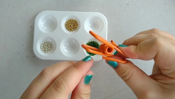 Attach clips to the ends of the string to hold the beads while stringing.