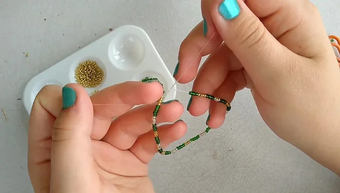 Tie a secure knot. The video demonstrates a double knot method. First, tie a regular knot. Then, pass the ends through the loop of the knot again before tightening to make a double knot. Repeat this process with the other set of ends, crossing the strings in the opposite direction the first time for extra security.