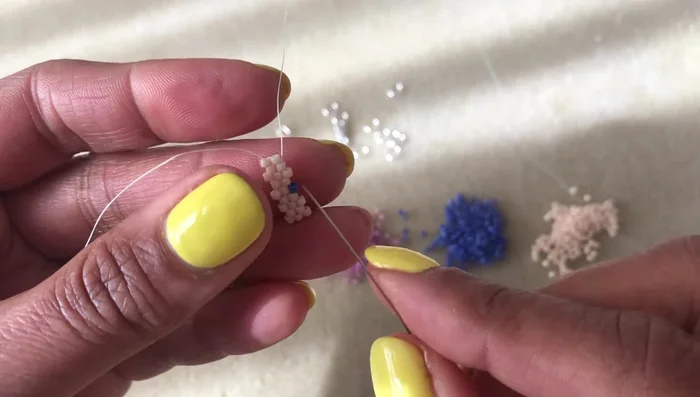 Odd count Peyote stitch turnaround: At the end of each row, pick up a bead, go *underneath* the thread bridge on the outside edge, then back up through the same bead. This creates an 'up' bead on the edge.