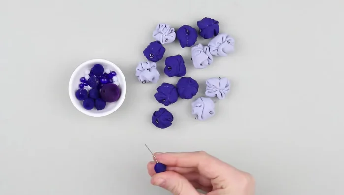 Thread decorative pins through big plastic beads, making loops.