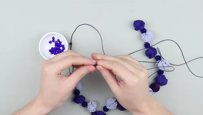 Thread the string through small plastic beads, securing each with knots.