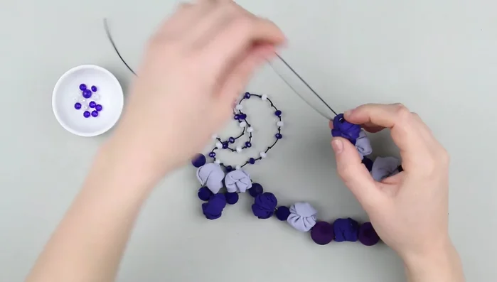 Pass the cord through the loop on the other side and tie several knots.