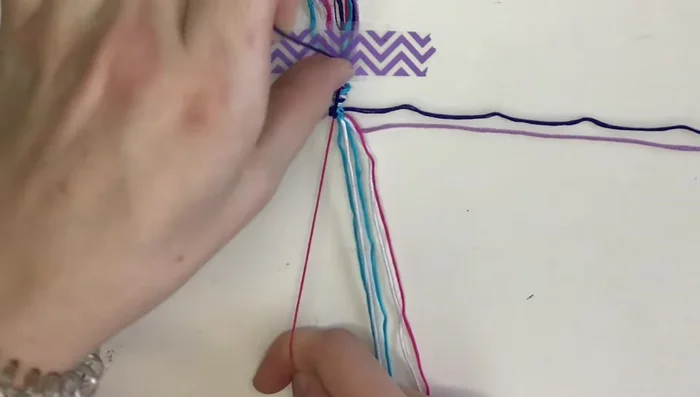 Create the outer triangles: Create small triangles on each side by using forward and backward knots.