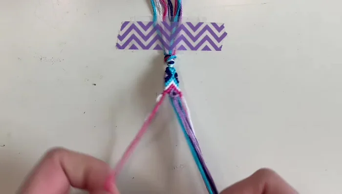 Complete the bracelet edges: Repeat step 5 on the opposite side, creating symmetrical triangles.