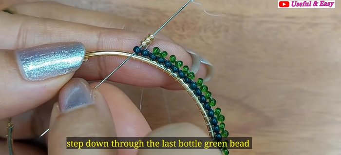 Green Ombre Hoop Earring (Herringbone Stitch): Add the fourth line with golden and parrot green beads using herringbone stitch.