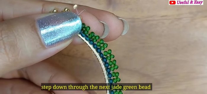 Green Ombre Hoop Earring (Herringbone Stitch): Add the fourth line with golden and parrot green beads using herringbone stitch.