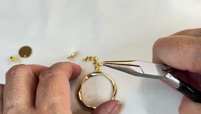 Attach the 7mm jump ring to the large disc and earring backing.