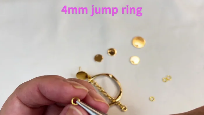 Attach the small discs using 4mm jump rings. Skip a link between each disc.