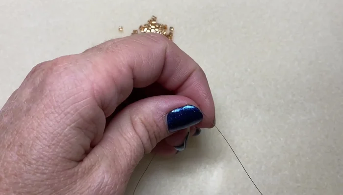 After completing the ladder stitch, go back and even out the beads by passing the needle up and down through each bead to straighten the row.