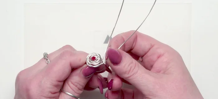 Final Shaping: Using chain nose pliers, make a few tight wraps on one side, securing the row. Use a ring vise to easily and tightly wrap the other side for a clean finish.