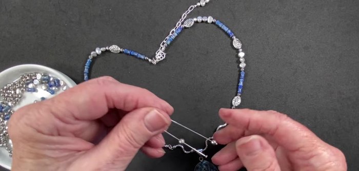 Create earrings using head pins and eye pins, stringing beads in a similar pattern as the necklace.