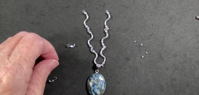 Attach one end of each wire to a clamshell bead tip using crimp beads. Secure the crimp bead by crimping it with pliers.