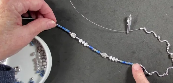 Adjust the bead placement and number of connectors to achieve the desired look. The creator removes a connector on each side to better showcase the beads.